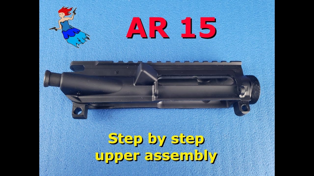AR-15 Upper Assembly – stripped upper receiver on blue background for step-by-step tutorial