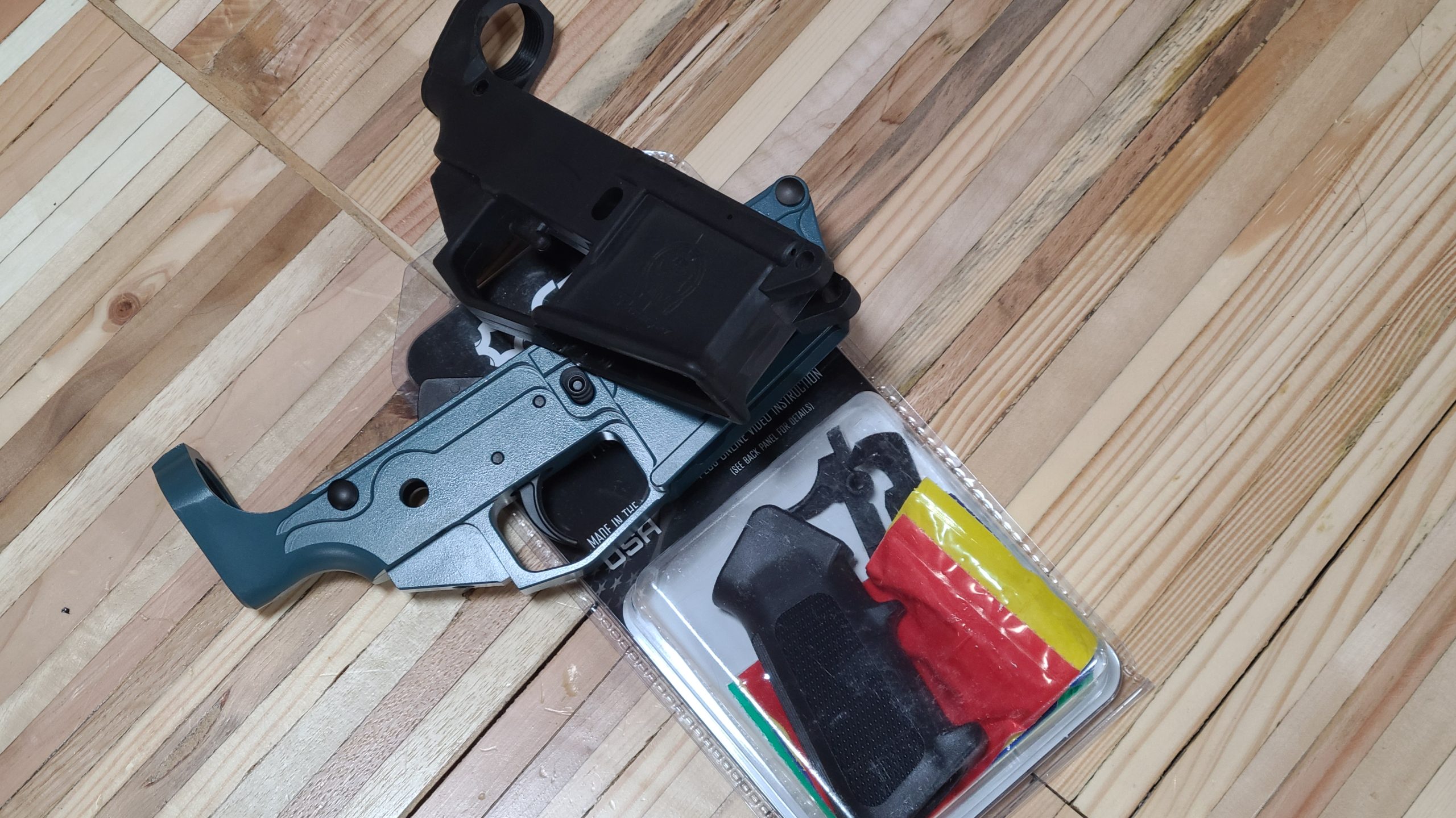 Tools and parts needed to assemble an AR-15 lower receiver laid out for a clean DIY build