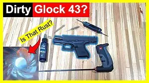 Top-down view of Glock 43 pistol disassembled for cleaning with tools, lubricant, and a bore inspection image highlighting possible rust, overlaid with bold yellow and red warning-style text asking &ldquo;Dirty Glock 43?&rdquo; and &ldquo;Is That Rust?&rdquo;