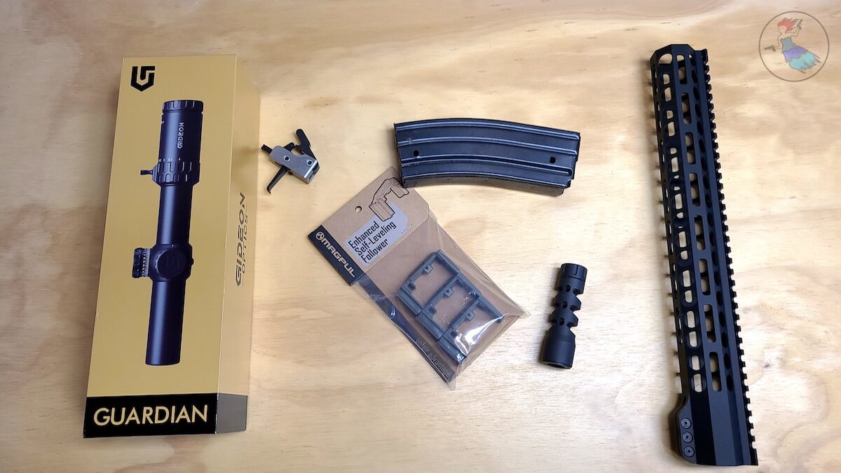 AR-15 upgrades to make your rifle run better – optic, trigger, muzzle brake, magazine follower, and handguard laid out on a workbench